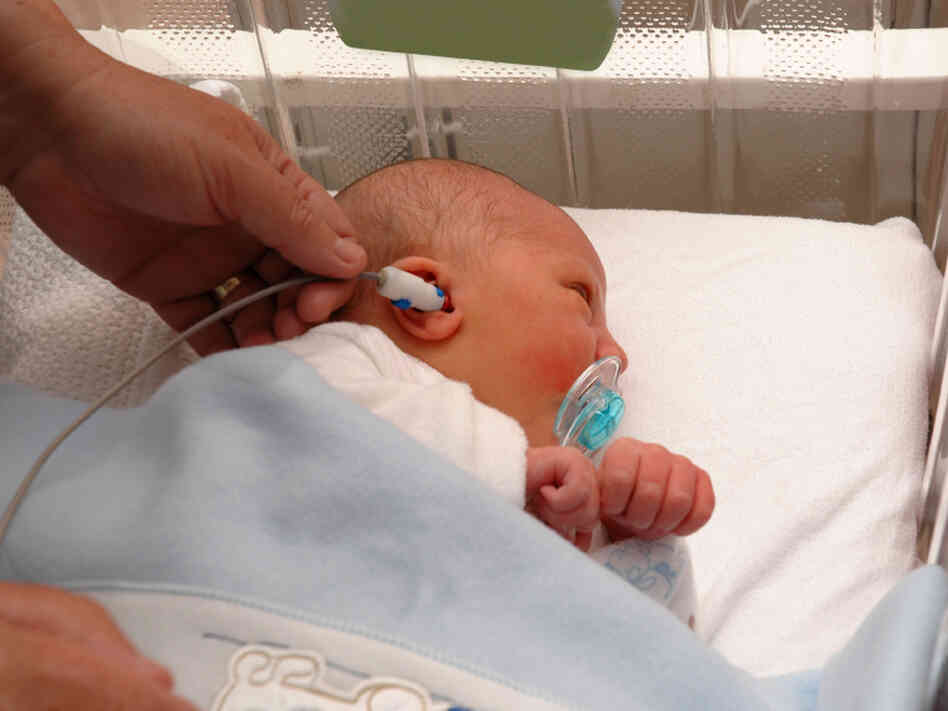 A newborn gets a hearing test. Cytomegalovirus is a major cause of hearing loss in babies.