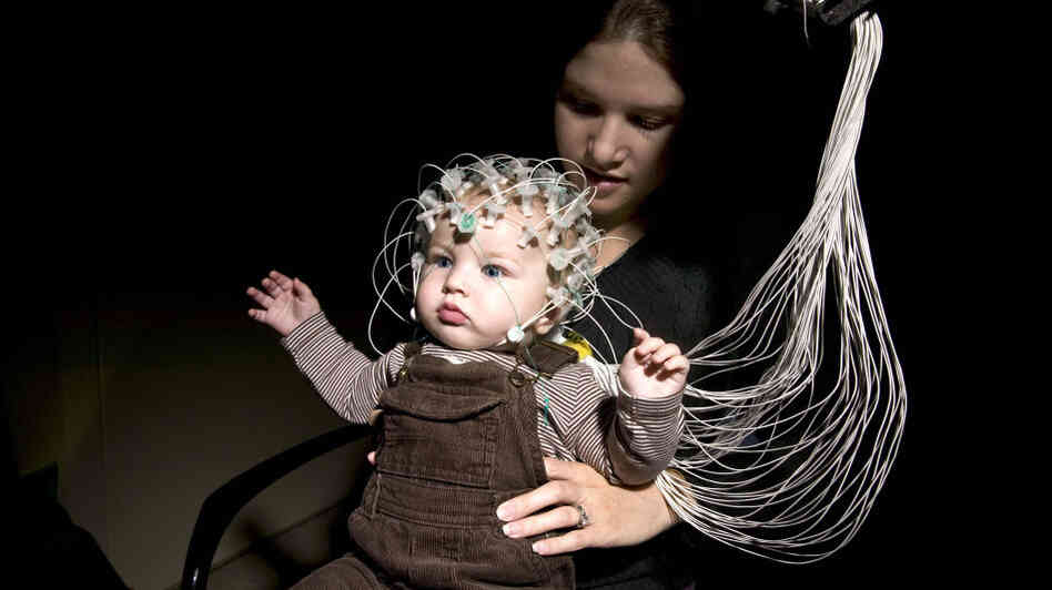 An infant and his mother demonstrate electroencephalography, or EEG, technology at Children's Hospital Boston. The technology could help detect the risk of autism in infants. An infant and his mother demonstrate electroencephalography, or EEG, technology at Children's Hospital Boston. The technology could help detect the risk of autism in infants.