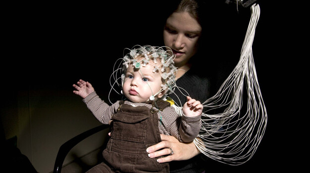 An infant and his mother demonstrate electroencephalography, or EEG, technology at Children's Hospital Boston. The technology could help detect the risk of autism in infants. An infant and his mother demonstrate electroencephalography, or EEG, technology at Children's Hospital Boston. The technology could help detect the risk of autism in infants.