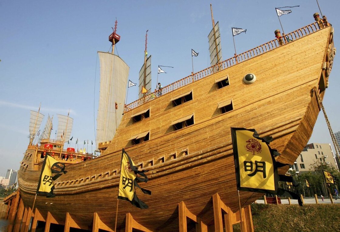 Tourists look out from a replica of the treasure ship. The ships sailed in enormous fleets.