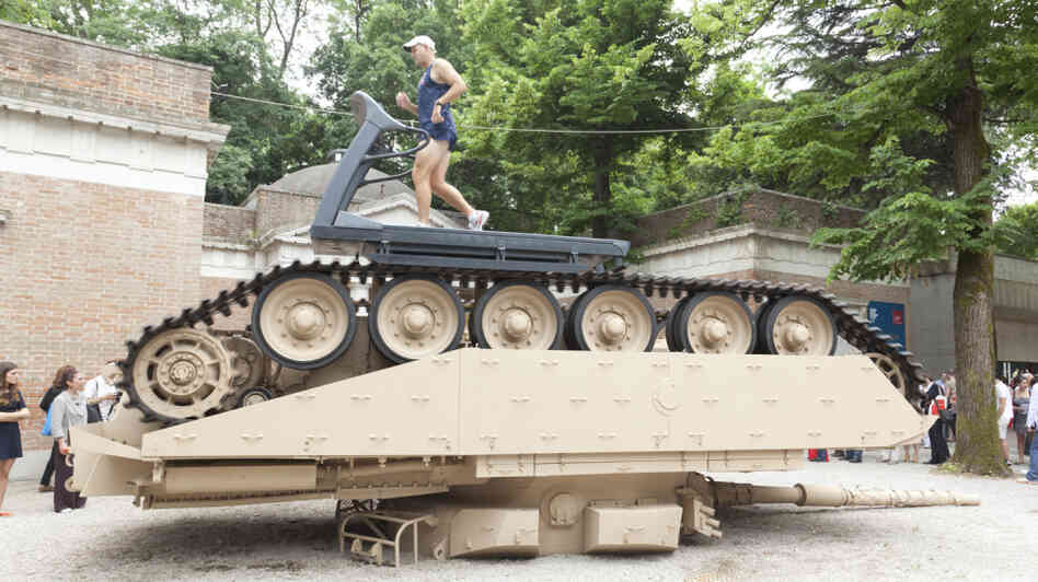 Former Olympian Gary Morgan runs on a treadmill atop an overturned tank in Track and Field, by Jennifer Allora and Guillermo Calzadilla. The piece is part of the American Pavilion at the Venice Biennale.