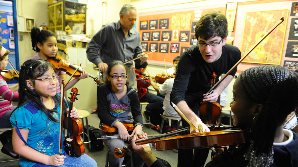 Nathan Schram instructs students in the classroom.