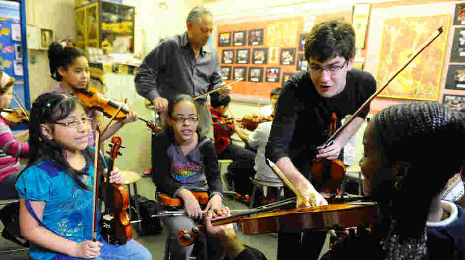 Nathan Schram instructs students in the classroom.