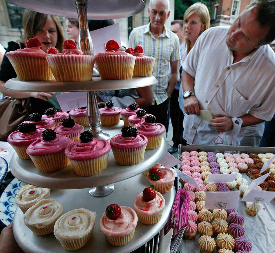 Customers look at the cupcakes in London, England.
