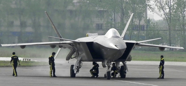 A J-20 stealth fighter is inspected by Chinese air force ground crew members in Chengdu on April 17. China performed the first test flight of the J-20 during a visit by U.S. Defense Secretary Robert Gates in January.