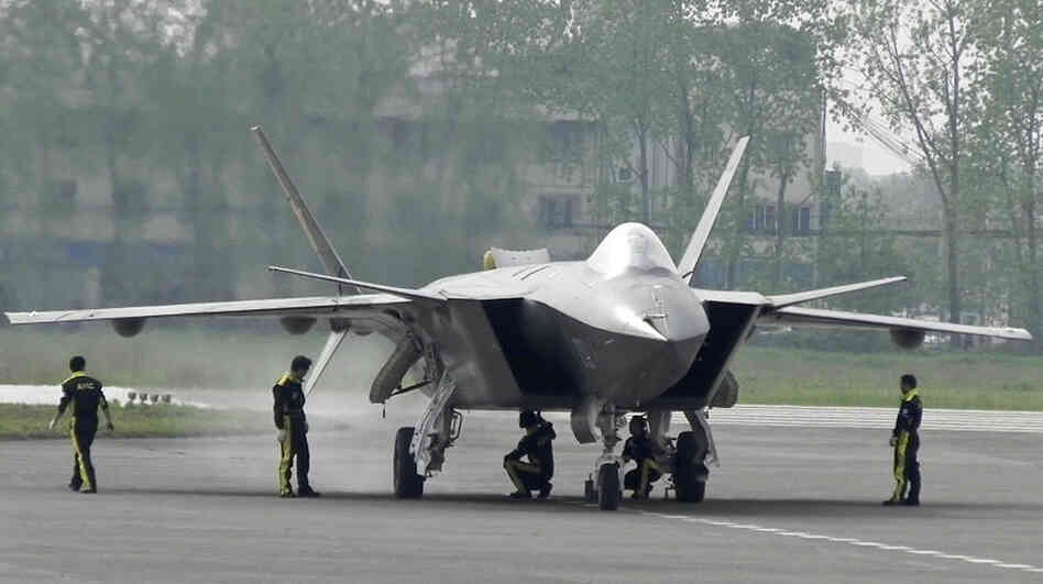 A J-20 stealth fighter is inspected by Chinese air force ground crew members in Chengdu on April 17. China performed the first test flight of the J-20 during a visit by U.S. Defense Secretary Robert Gates in January.