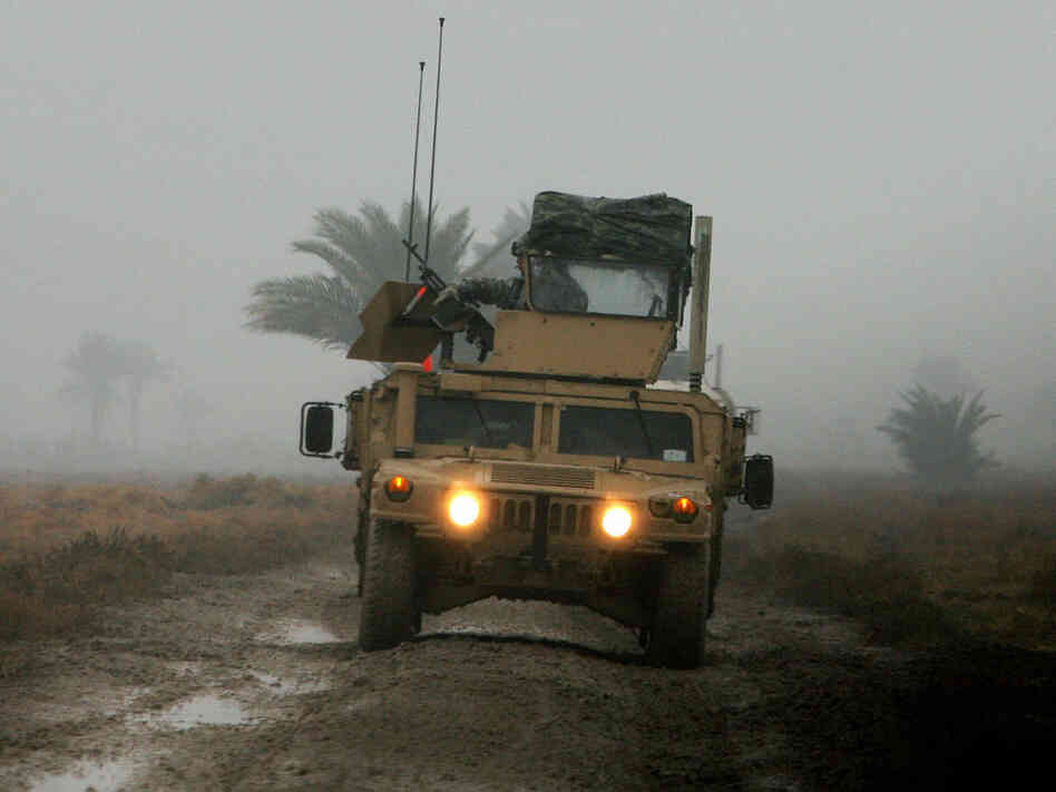 A U.S. soldier from the 6th Squadron, 8th Cavalry Regiment, mans a machine gun on top of a Humvee as it navigates a muddy road on the southern outskirts of Baghdad. A U.S. soldier from the 6th Squadron, 8th Cavalry Regiment, mans a machine gun on top of a Humvee as it navigates a muddy road on the southern outskirts of Baghdad.