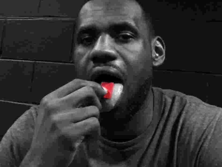 In a screen shot from a promotional video for a new energy product, NBA star LeBron James places a bright red gel strip on his tongue. In a screen shot from a promotional video for a new energy product, NBA star LeBron James places a bright red gel strip on his tongue.