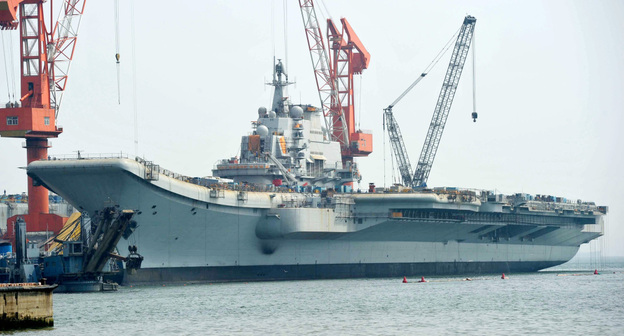 The Varyag aircraft carrier, shown April 26, is being renovated at a shipyard in the northern Chinese city of Dalian. After years of refurbishing work, the carrier — bought from Ukraine — has been described as "on the verge of setting out" by Xinhua state news agency.
