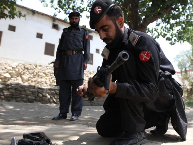 Frontier Constabulary troops return to Shabqadar Fort regularly for refresher courses on weapons and tactics. This man is assembling and disassembling a rifle under the watchful eye of his instructor.