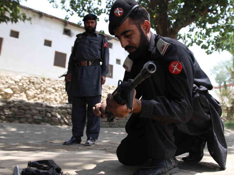 Frontier Constabulary troops return to Shabqadar Fort regularly for refresher courses on weapons and tactics. This man is assembling and disassembling a rifle under the watchful eye of his instructor.