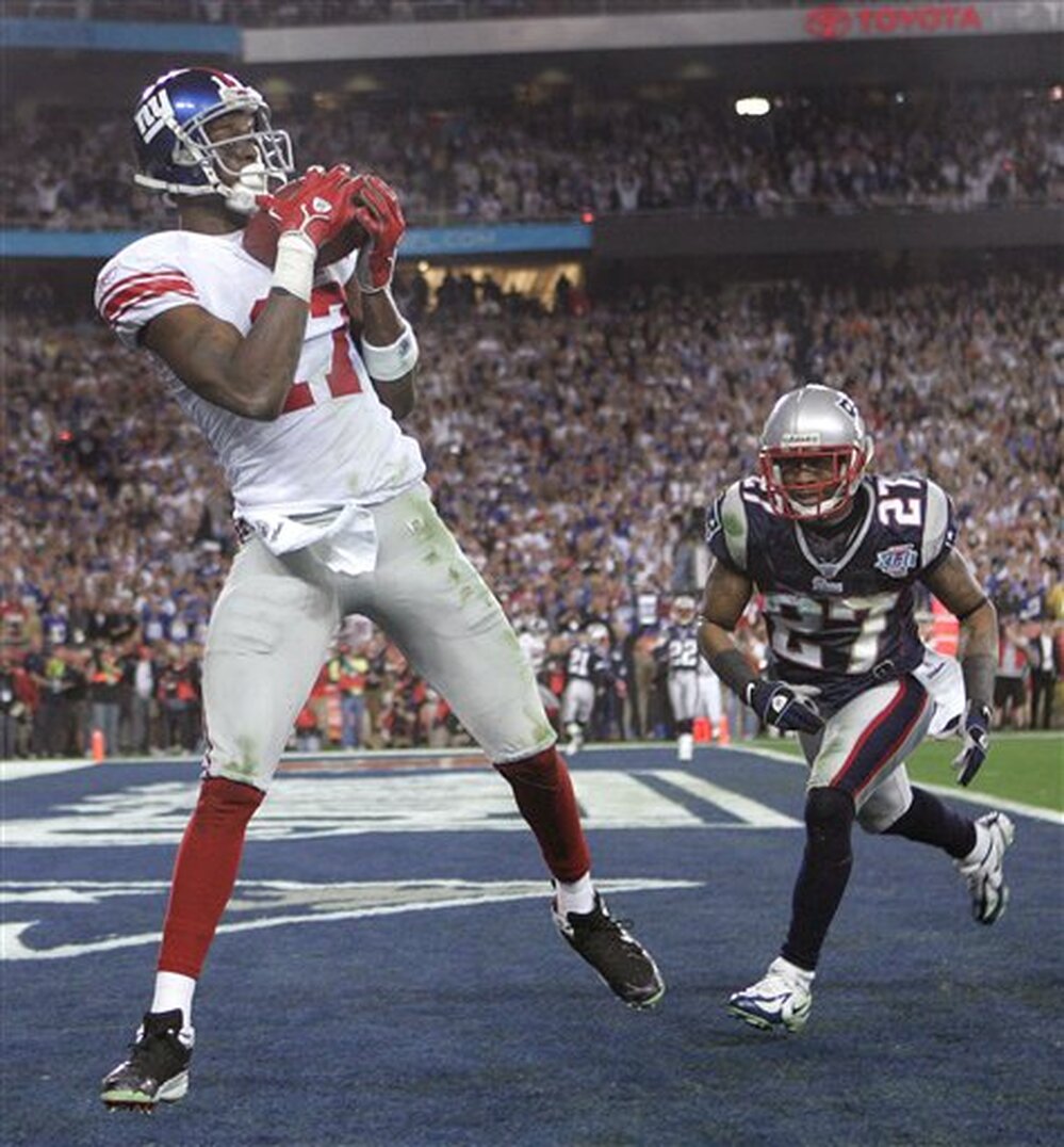 Feb. 3, 2008: then-New York Giants receiver Plaxico Burress, left, catches the game-winning touchdown pass in front of New England Patriots' Ellis Hobbs III during the final minute of Super Bowl XLII.