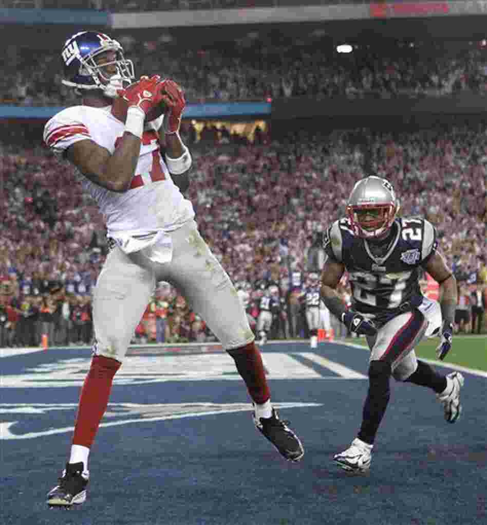 Feb. 3, 2008: then-New York Giants receiver Plaxico Burress, left, catches the game-winning touchdown pass in front of New England Patriots' Ellis Hobbs III during the final minute of Super Bowl XLII.