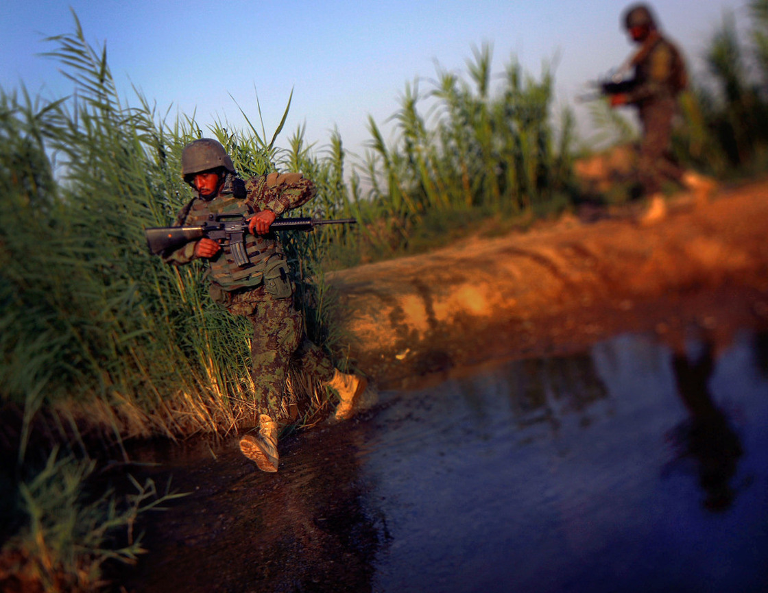 Afghan National Army Soldiers cross a stream while on a joint patrol with U.S. Marines in Northern Marjah, Helmand Province, Afghanistan.