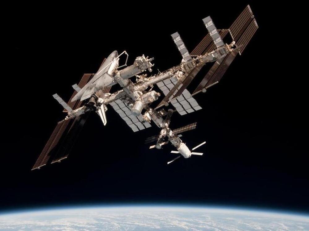 The International Space Station and the docked space shuttle Endeavour, flying at an altitude of approximately 220 miles, on May 23, 2011.