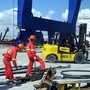 Employees of China's state-run Cosco company work at the port in Greece on Sept. 13, 2010. The company is accused by Greek unionists and by employees of importing Chinese labor practices.