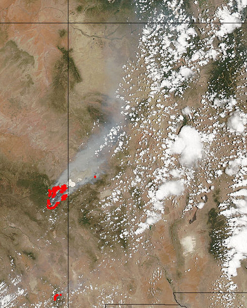 This satellite image from NASA's MODIS Land Rapid Response Team shows the fires in red, along the Arizona border with New Mexico (the line just to the right of the red marks that pinpoint the flames), and the smoke billowing to the northeast. It was taken Monday.