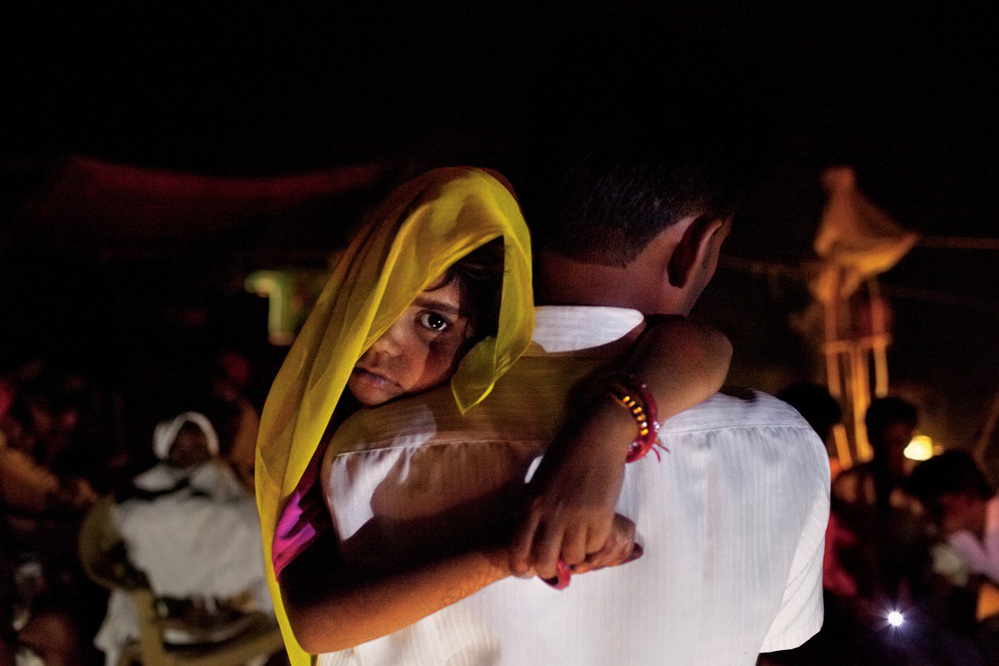 Long after midnight, 5-year-old Rajani is roused from sleep and carried by her uncle to her wedding. Child marriage is illegal in India, so ceremonies are often held in the wee hours of morning. It becomes a secret the whole village keeps, explained one farmer.