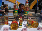 A Chinese man stands behind counterfeit cooking oil products placed next to the authentic ones during an event in Beijing Sunday to promote awareness of economic crimes. A Chinese man stands behind counterfeit cooking oil products placed next to the authentic ones during an event in Beijing Sunday to promote awareness of economic crimes.