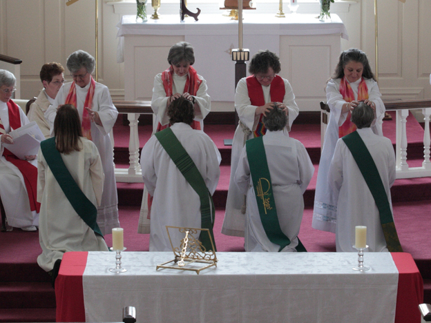 In the "laying on of hands" during the ordination ceremony, the priests place their hands on the candidates before they are officially ordained. The future priests are (from left): Ann Penick, Marellen Mayers, Patricia "Patti" LaRosa and  Caryl Johnson.