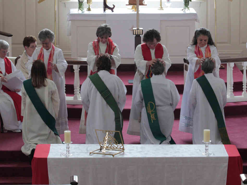 In the "laying on of hands" during the ordination ceremony, the priests place their hands on the candidates before they are officially ordained. The future priests are (from left): Ann Penick, Marellen Mayers, Patricia "Patti" LaRosa and  Caryl Johnson.