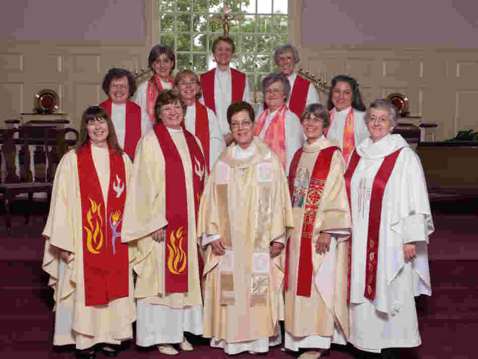 Marellen Mayers (front, second from left) and Patti LaRosa (front, far right) join hands with fellow members of the Roman Catholic Womenpriests movement on their ordination day.