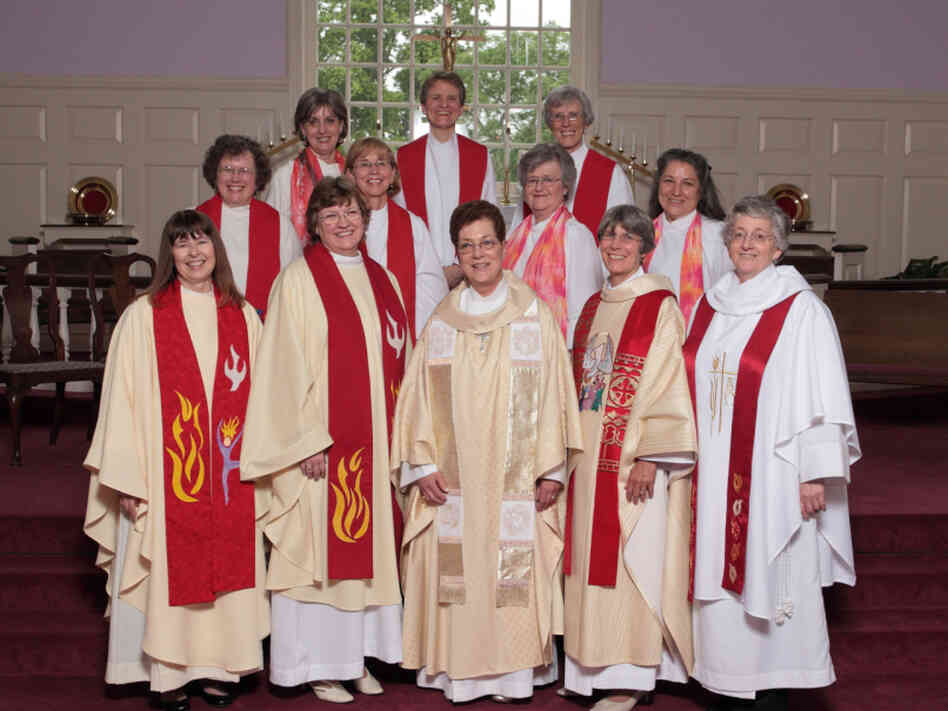 Marellen Mayers (front, second from left) and Patti LaRosa (front, far right) join hands with fellow members of the Roman Catholic Womenpriests movement on their ordination day.