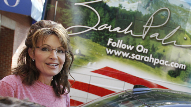 Former Alaska Gov. Sarah Palin stands near her tour bus outside a hotel in Boston on June 2.