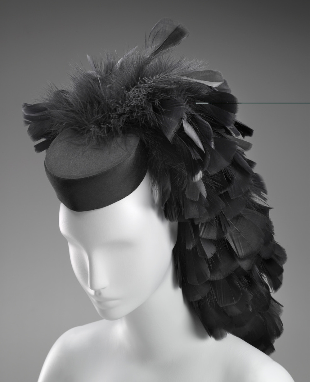 A cocktail hat circa 1963 by Cristobal Balenciaga. Silk, tulle, feathers, plastic, satin weave.