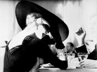 Lillian Bassman's photograph The V‐Back Evenings shows model and actress Suzy Parker having a drink (and some fun) in 1955. Lillian Bassman's photograph The V‐Back Evenings shows model and actress Suzy Parker having a drink (and some fun) in 1955.