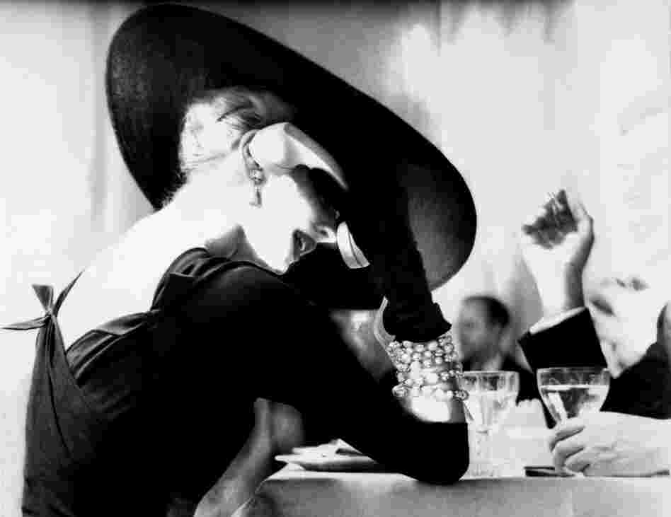 Lillian Bassman's photograph The V‐Back Evenings shows model and actress Suzy Parker having a drink (and some fun) in 1955.