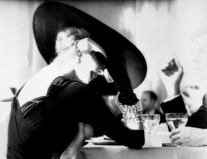 Lillian Bassman's photograph The V‐Back Evenings shows model and actress Suzy Parker having a drink (and some fun) in 1955.