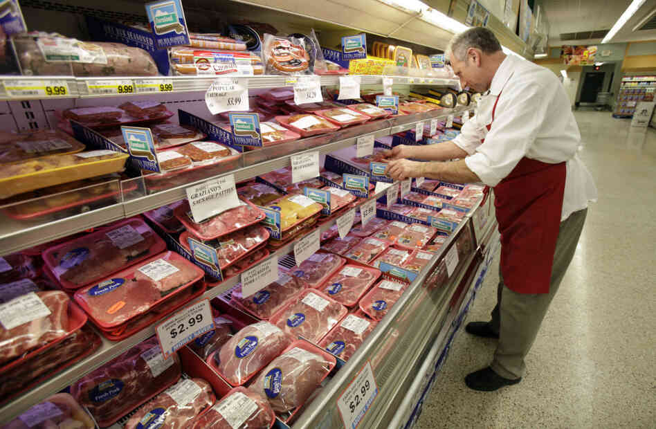 Kevin Morlan arranges packages of pork at a local Dahl's grocery store in Des Moines, Iowa. Economists are predicting meat prices will rise 7 percent this year.