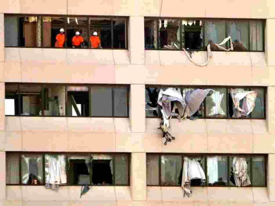 Workers look out from shattered windows on an upper floor of the St. John's Regional Medical Center in Joplin, Mo., in late May, after a tornado severely damaged the hospital.