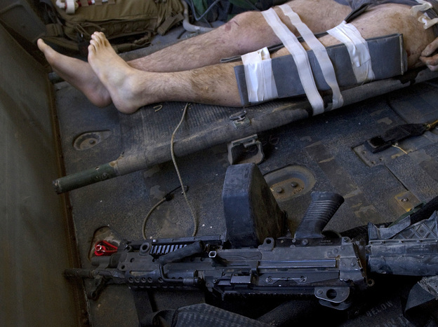 A NATO soldier wounded by an IED explosion lies in a helicopter during an emergency airlift in Kandahar province, southern Afghanistan on October 12, 2010.  Bombs, not bullets, are the main threat to soldiers in Iraq and Afghanistan. (Getty Images)