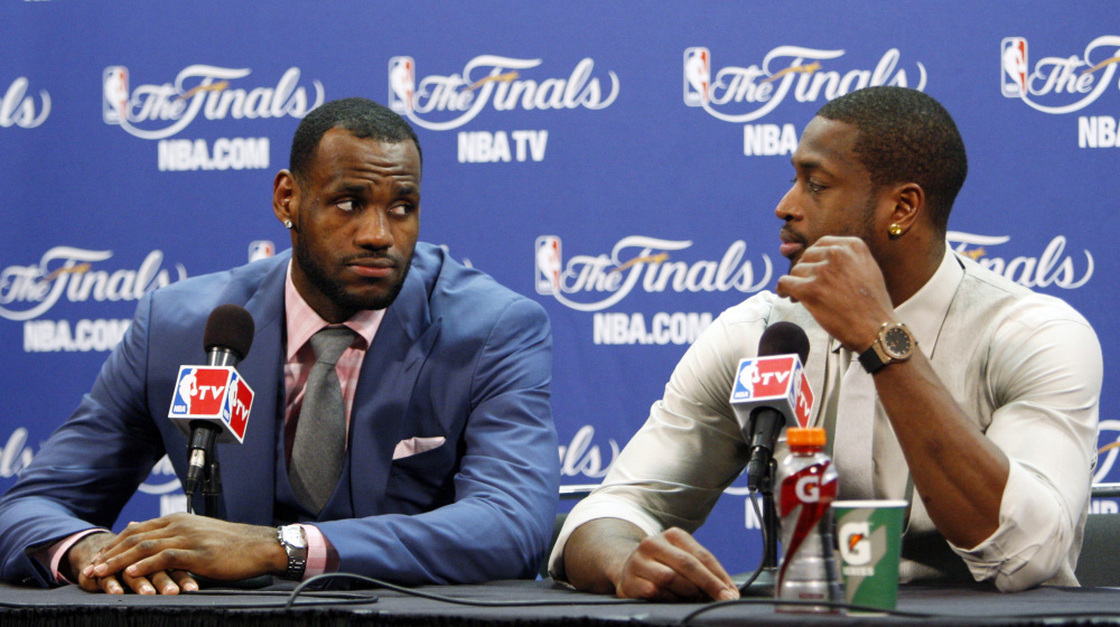 James looks at teammate Dwyane Wade during the news conference.