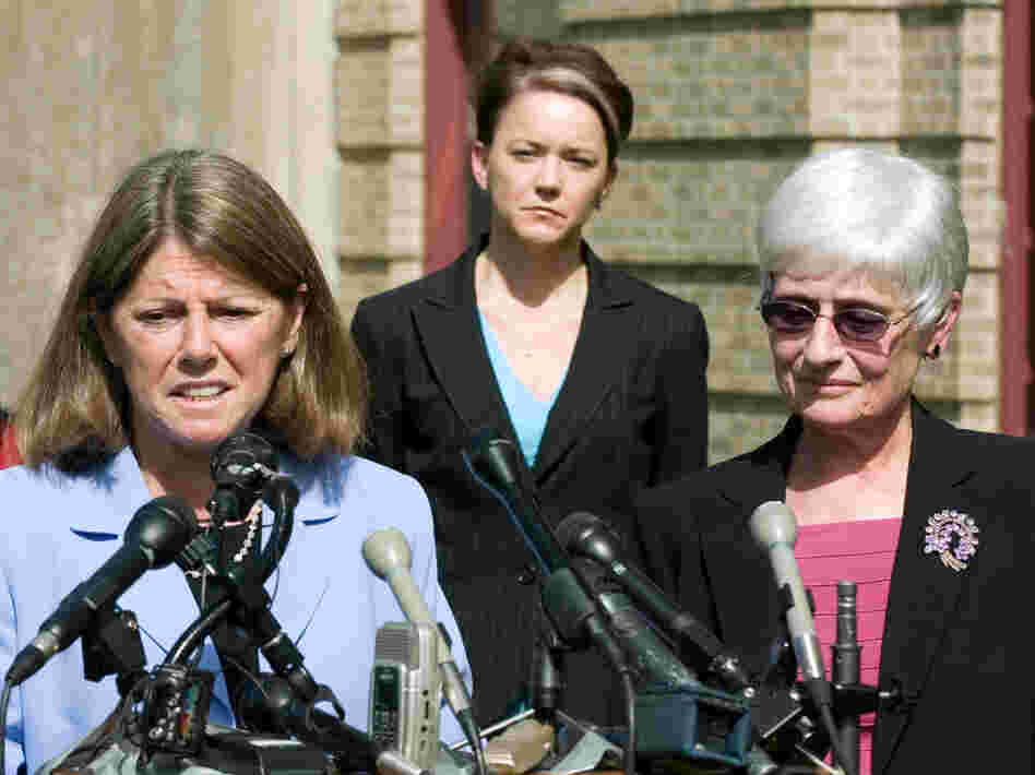 Rhode Island Education Commissioner Deborah Gist, (center) looks on as Central Falls School Superintendent Frances Gallo (right) and Central Falls Teachers' Union President Jane Sessums (left) talk to the media just after the union approved an agreement allowing the entire staff to be rehired last May.