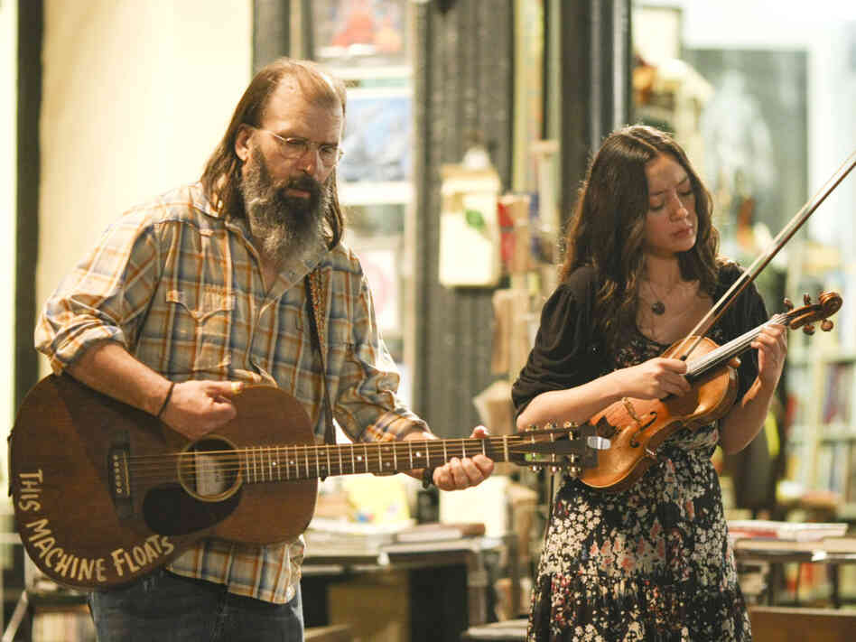 Harley (Steve Earle, left) and Annie (Lucia Micarelli) busk in the French Quarter in Treme.