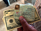 July 21, 2003: A former Iraqi Army officer holds his military I.D. and an emergency cash payment of $80. July 21, 2003: A former Iraqi Army officer holds his military I.D. and an emergency cash payment of $80.