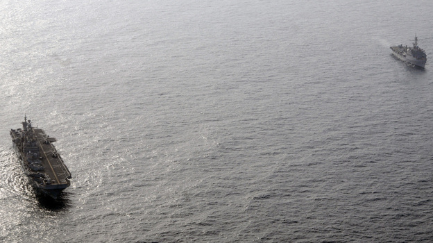 The amphibious assault ship USS Peleliu (L) and the amphibious transport dock ship USS Dubuque in the Arabian Sea off the coast of Pakistan.