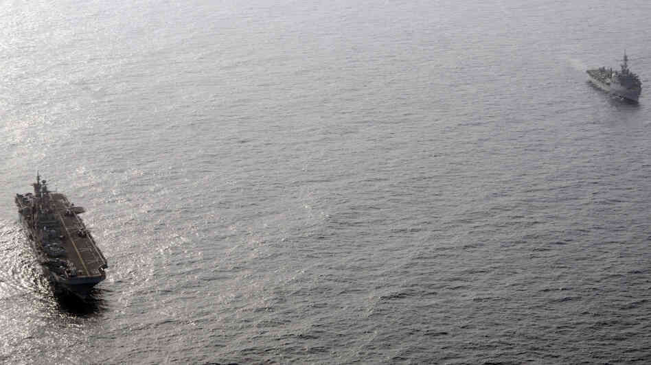 The amphibious assault ship USS Peleliu (L) and the amphibious transport dock ship USS Dubuque in the Arabian Sea off the coast of Pakistan.
