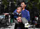 A man carries his son at a Beijing park. China's one-child policy has been blamed for the current gender-imbalance in China, where sex-specific abortions remain common.