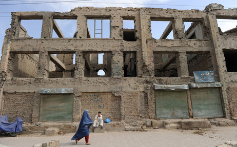 A burqa-clad Afghan woman walks past the ruins of a building destroyed during the civil war in Kabul. This picture was taken June 13. A burqa-clad Afghan woman walks past the ruins of a building destroyed during the civil war in Kabul. This picture was taken June 13.