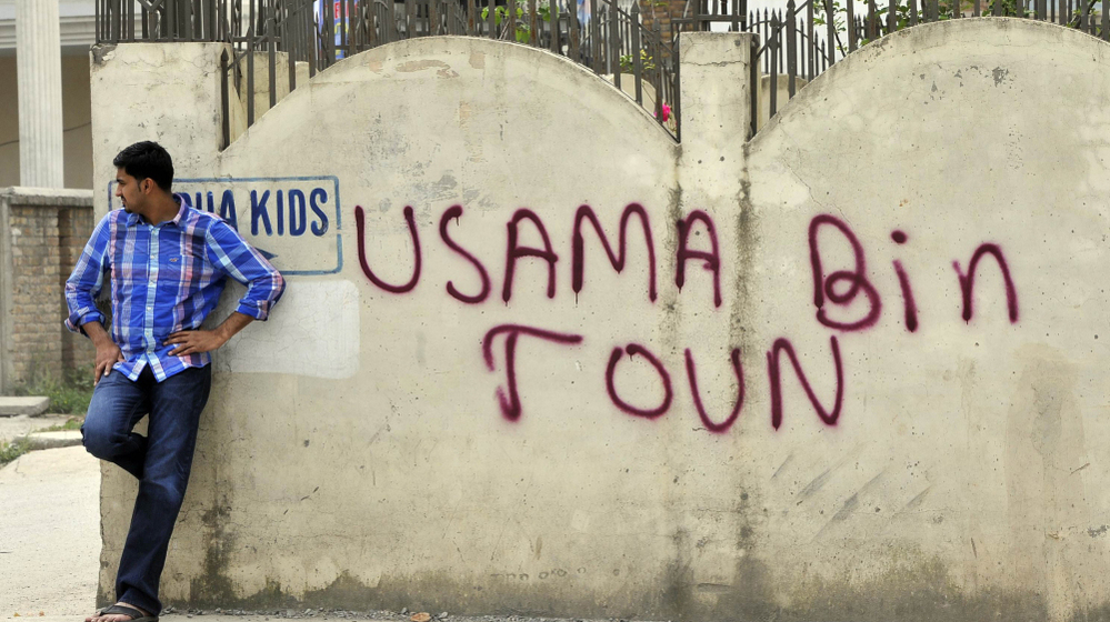 May 6, 2011: A man leans against a wall in Abbottabad, Pakistan, near the compound where al-Qaida leader Osama bin Laden was discovered and killed.