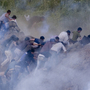 Pro-Palestinian protesters run from tear gas fired by Israeli troops along the border between Israel and Syria on June 5. Israeli troops battled hundreds of pro-Palestinian protesters who tried to burst across Syria's frontier with the Golan Heights, killing a reported 20 people and wounding scores more. Pro-Palestinian protesters run from tear gas fired by Israeli troops along the border between Israel and Syria on June 5. Israeli troops battled hundreds of pro-Palestinian protesters who tried to burst across Syria's frontier with the Golan Heights, killing a reported 20 people and wounding scores more.