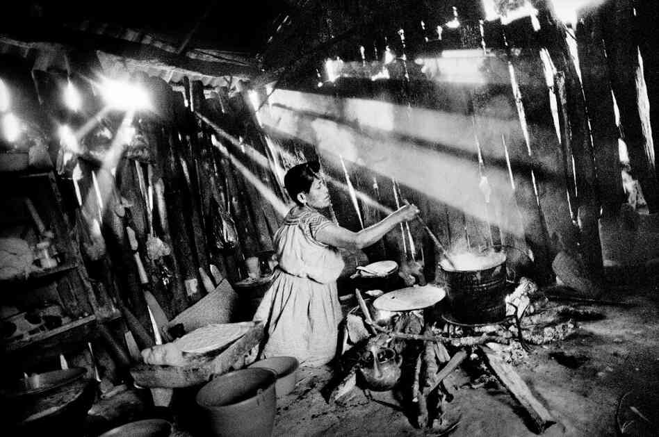 In the kitchen of her home, a woman boils corn to make tortillas, San Miguel Cuevas, Mexico. In the kitchen of her home, a woman boils corn to make tortillas, San Miguel Cuevas, Mexico.