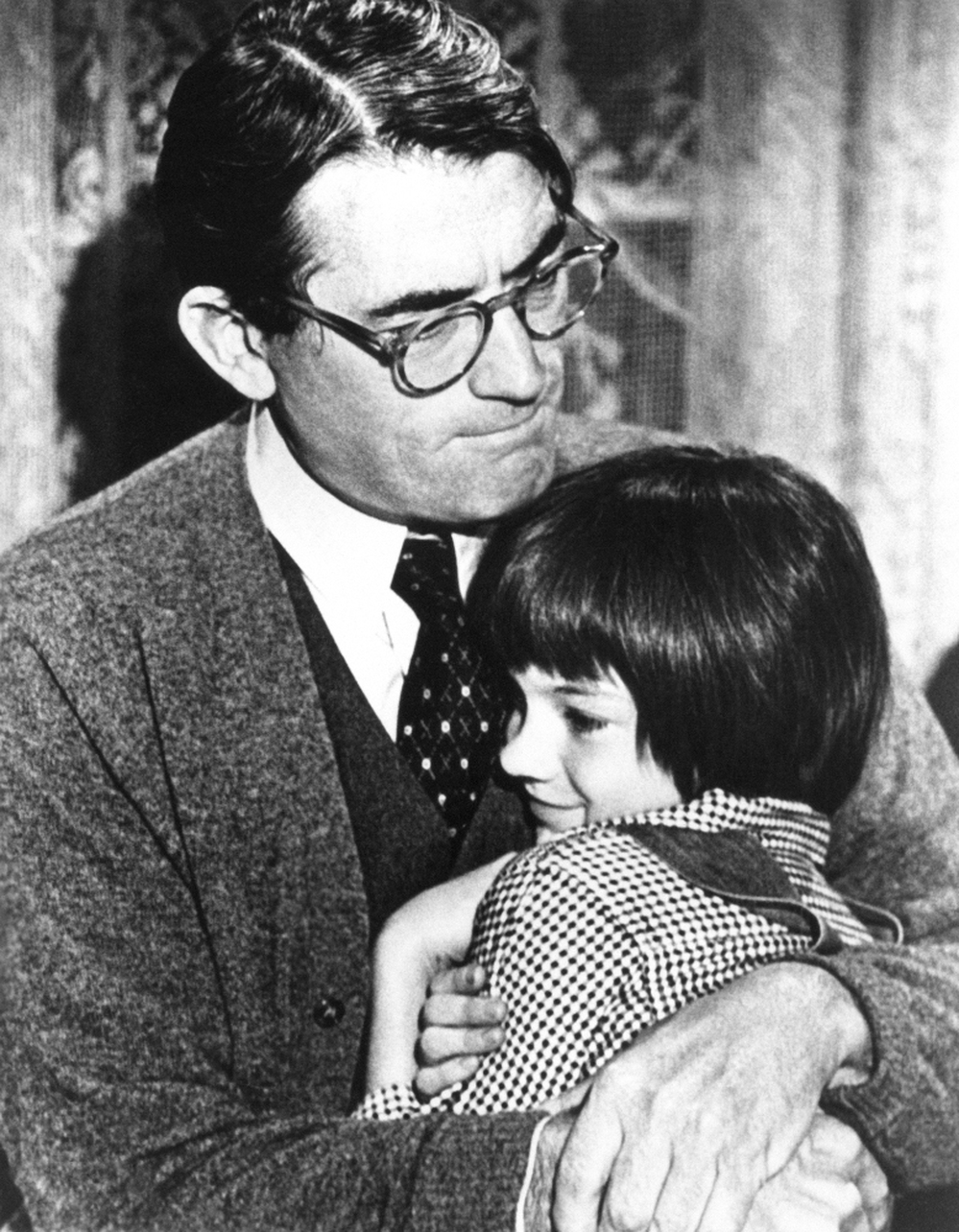Gregory Peck embraces Mary Badham, 9, a Birmingham Alabama acting discovery who plays his daughter in "To Kill a Mockingbird"  March 1963.