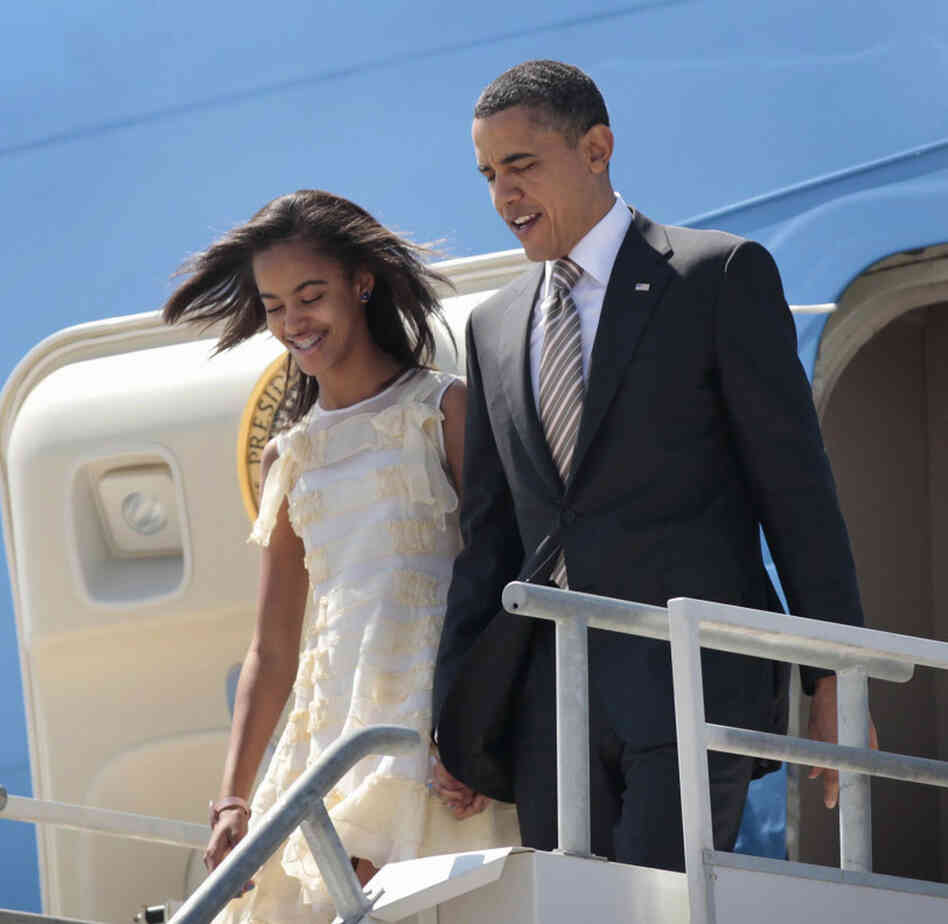 President Barack Obama and his daughter Malia arrive in Santiago, Chile. Asked how he would feel about Malia starting to date, the president quipped, in a reference to the Secret Service, that "I have men with guns who surround them all the time ... and it means they never get in a car with a boy who had a beer."