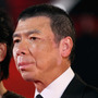 Director Feng Xiaogang, whose 2010 film Aftershock is China's highest-grossing Chinese-made film of all time, arrives at the 14th Shanghai International Film Festival. At left is his wife Xu Fan, who starred in Aftershock.