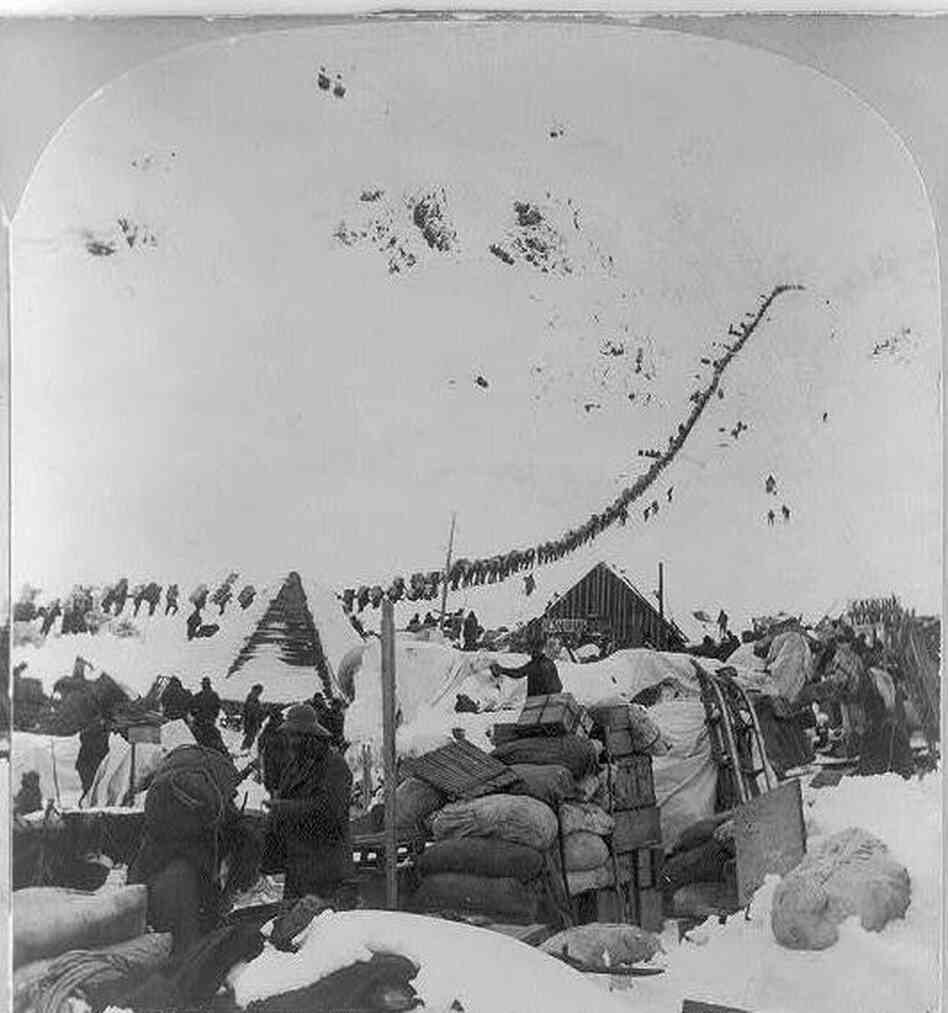 A long line of 19th-century prospectors make their way to Canada's Klondike gold fields through the Chilkoot   Pass in Alaska.